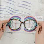 Detailed view of an optician using a ruler to measure eyeglass lenses for optical fitting.