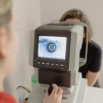 Close-up of eye diagnostic machine being used during an eye examination in a clinic setting.