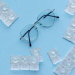 Eyeglasses and contact lenses on a blue background. Concept of eye care and vision correction.