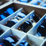 Close-up view of assorted sunglasses neatly arranged in display racks.